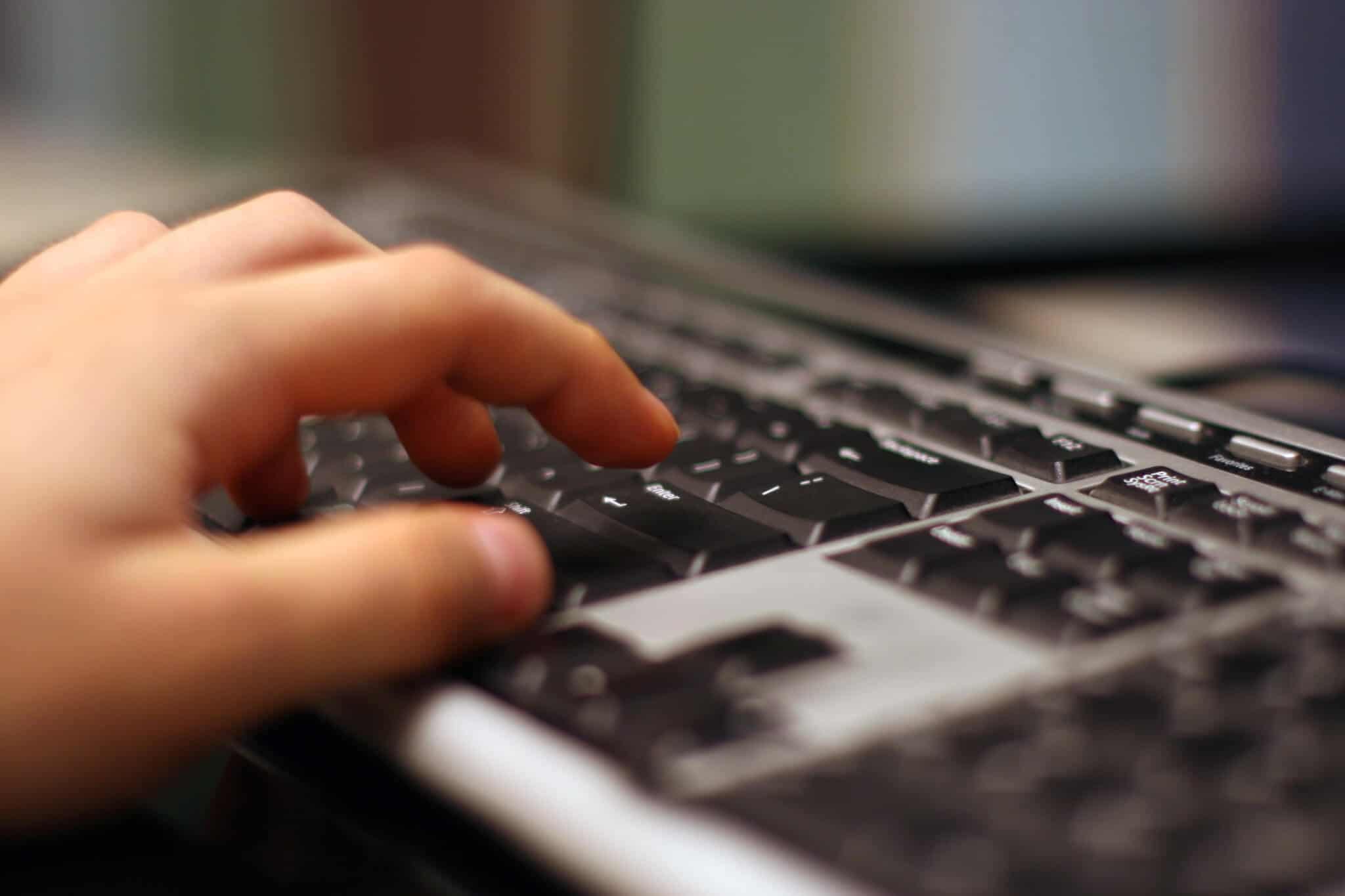 hand on computer keyboard