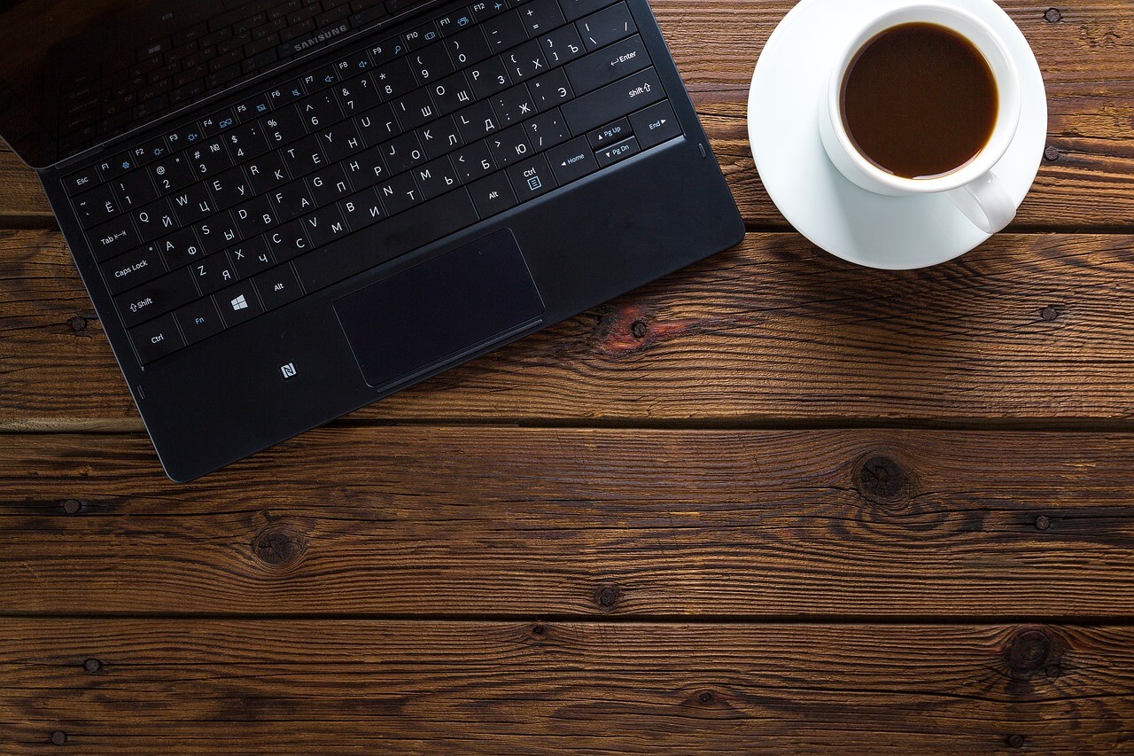 aerial shot of laptop and coffee