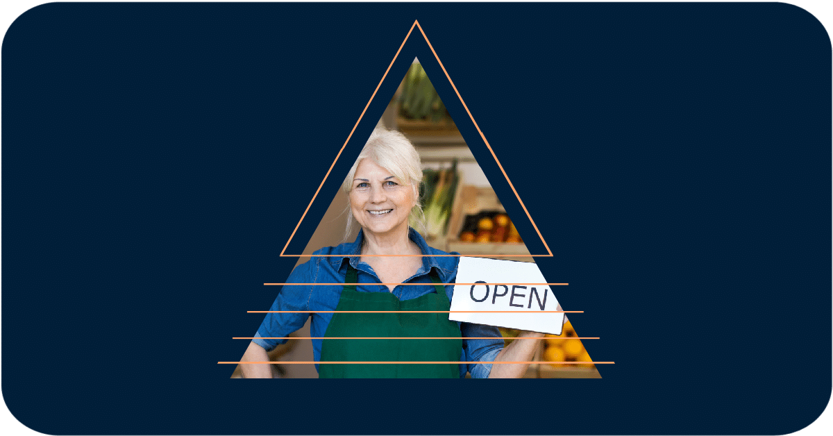 senior female shop owner with open sign