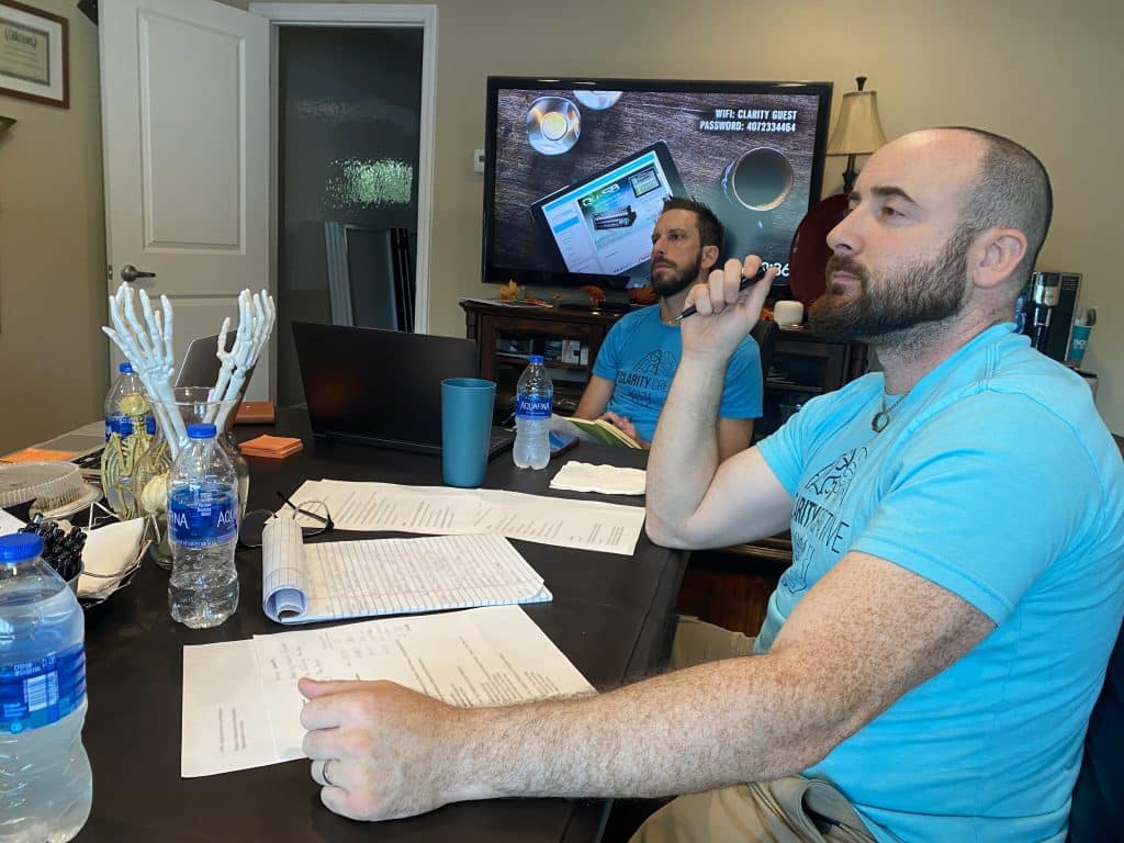 Craig and David of Clarity Creative Group listening to a client in office.