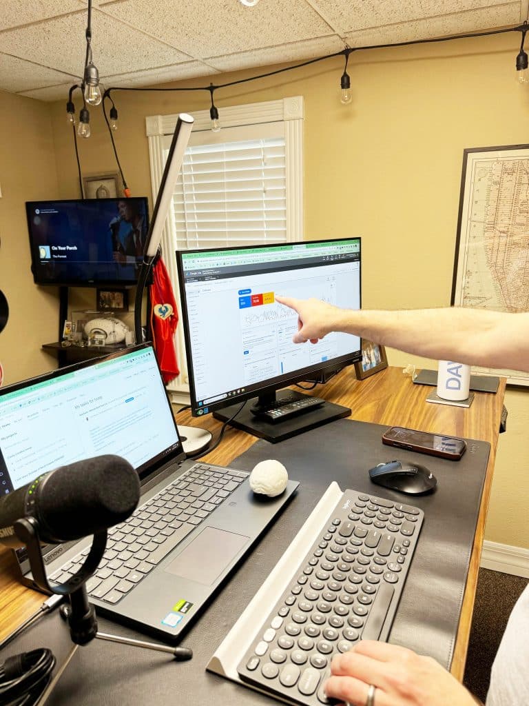 Man pointing at a computer screen displaying adwords